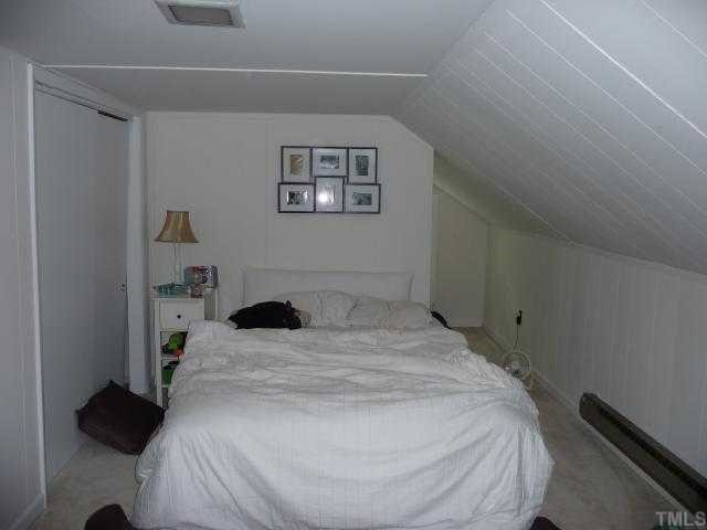 2711 Kittrell Drive Raleigh, NC 27608 - Photo 11 of 11 a bedroom with a bed and a cabinets