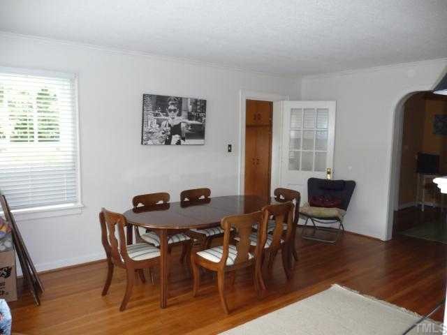 2711 Kittrell Drive Raleigh, NC 27608 - Photo 3 of 11 a view of a dining room with furniture and wooden floor