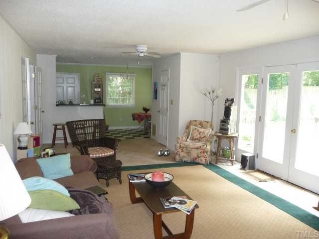 2711 Kittrell Drive Raleigh, NC 27608 - Photo 6 of 11 a living room with furniture and a table