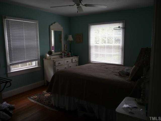 2711 Kittrell Drive Raleigh, NC 27608 - Photo 9 of 11 a bed sitting in a bedroom next to a window