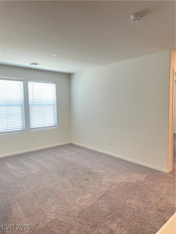 2444 Padulle Place Henderson, NV 89044 - Photo 7 of 11 Carpeted spare room featuring baseboards and visib