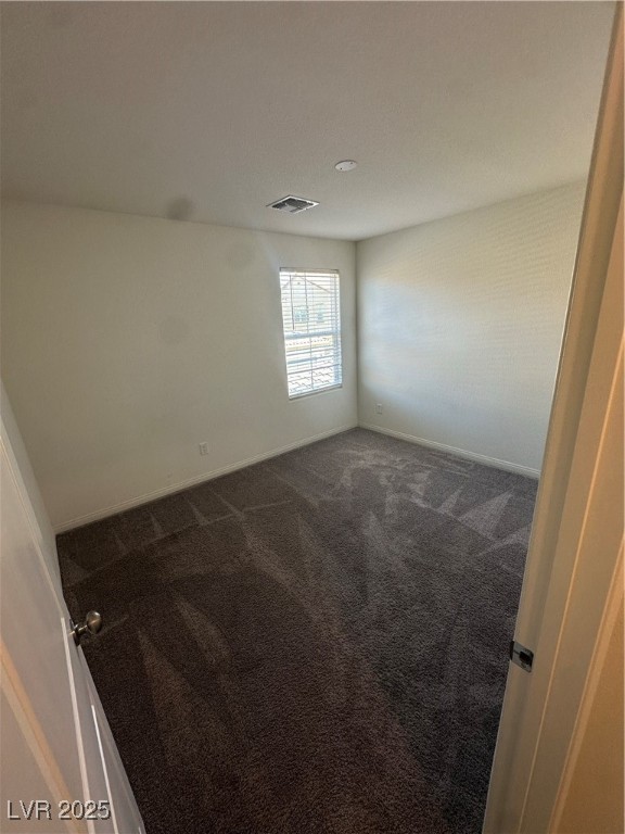 2444 Padulle Place Henderson, NV 89044 - Photo 8 of 11 Empty room with baseboards, dark colored carpet, a