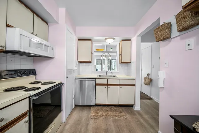 a kitchen with stainless steel appliances a sink dishwasher stove refrigerator and microwave