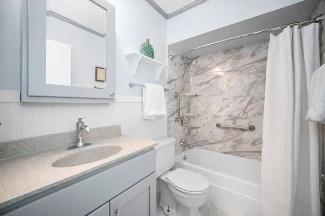 a bathroom with a sink toilet and shower