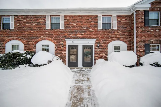 a front view of a house with yard and parking