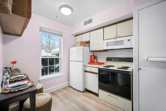 a kitchen with granite countertop a stove and a refrigerator