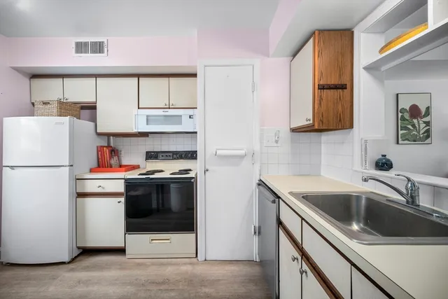 a kitchen with a sink and a refrigerator