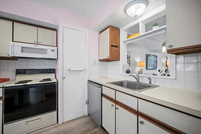 a kitchen with stainless steel appliances granite countertop a sink and a stove