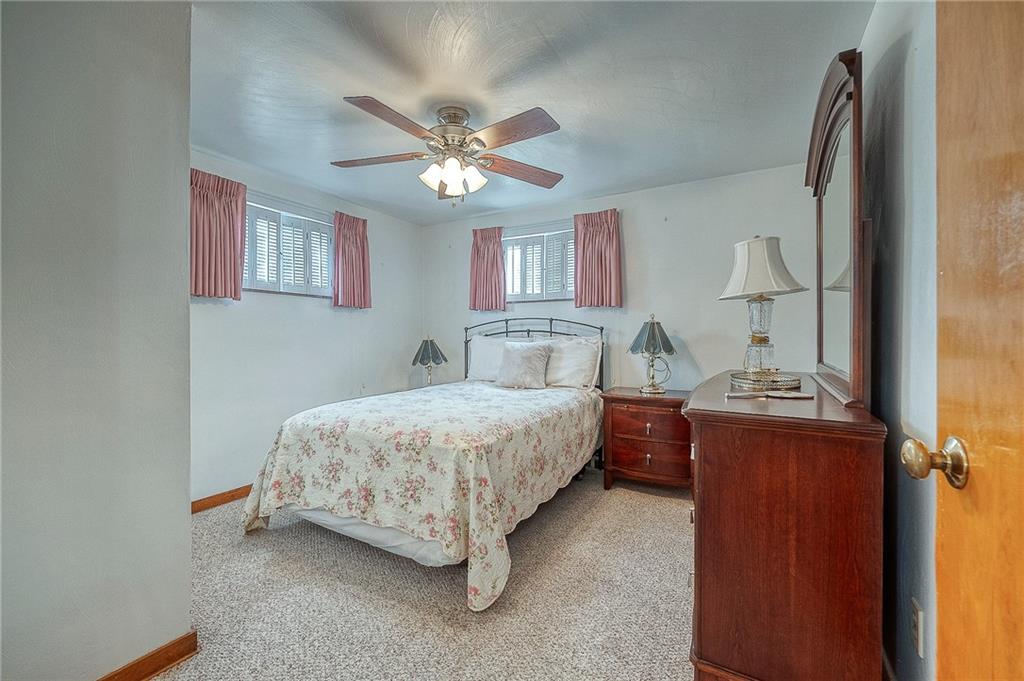 21 Spring Street Etna, PA 15223 - Photo 11 of 27 a bedroom with a bed and a chandelier