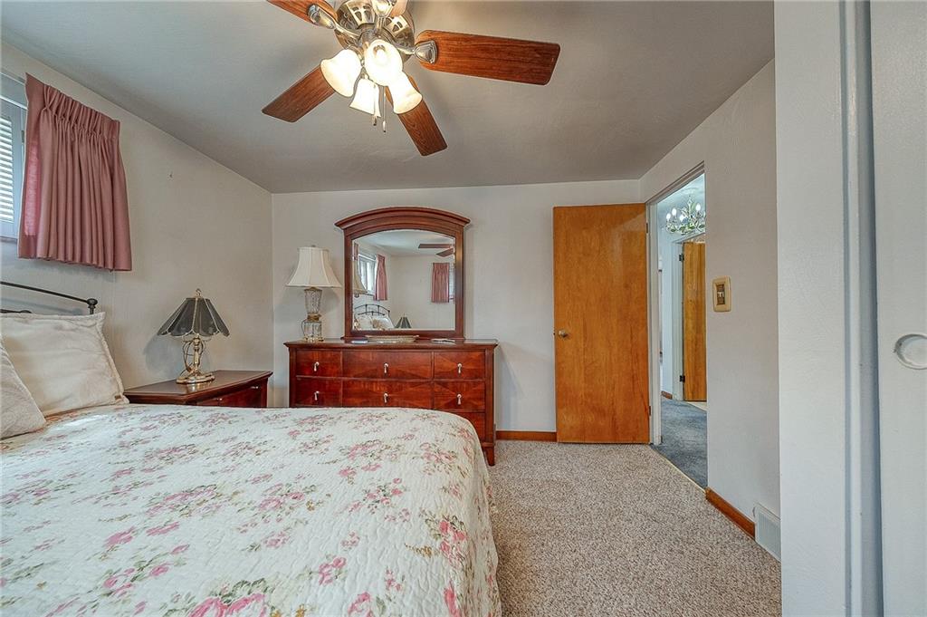 21 Spring Street Etna, PA 15223 - Photo 12 of 27 a bedroom with a bed and a chandelier