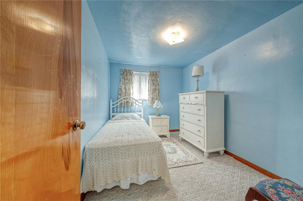 21 Spring Street Etna, PA 15223 - Photo 15 of 27 a bedroom with a bed and a cabinets