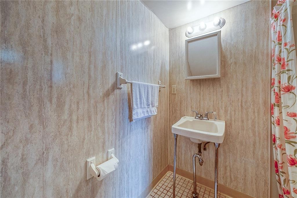 21 Spring Street Etna, PA 15223 - Photo 18 of 27 a bathroom with a sink a mirror and shower