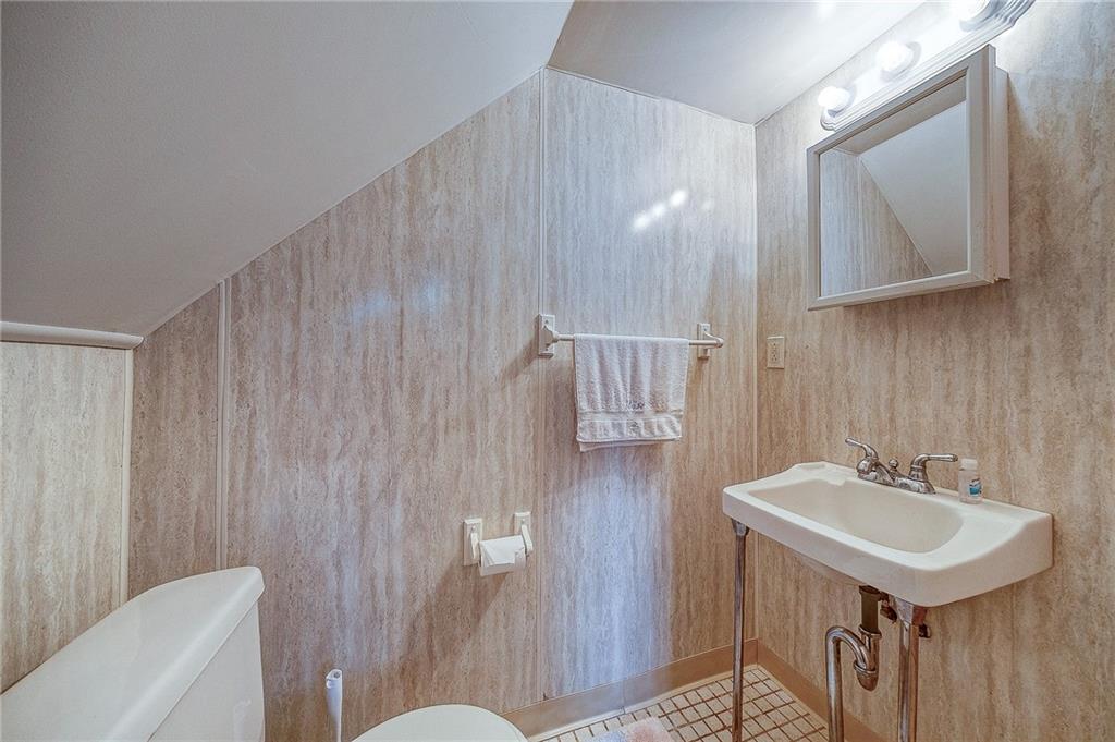 21 Spring Street Etna, PA 15223 - Photo 19 of 27 a bathroom with a sink a toilet and mirror