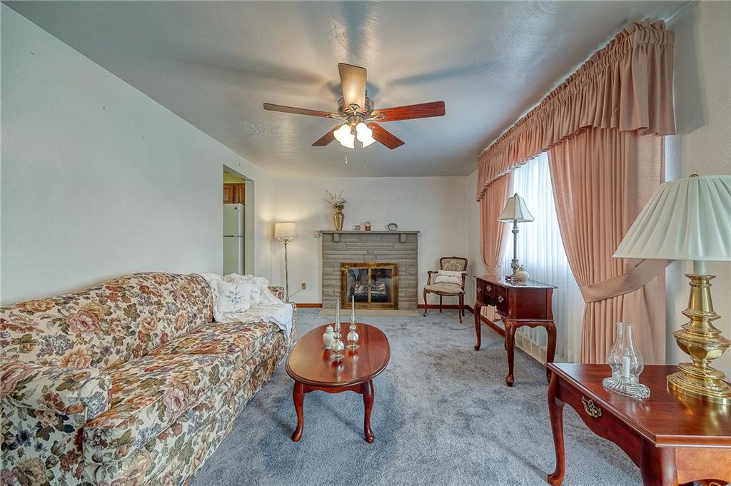 21 Spring Street Etna, PA 15223 - Photo 5 of 27 a living room with furniture a fireplace and a chandelier