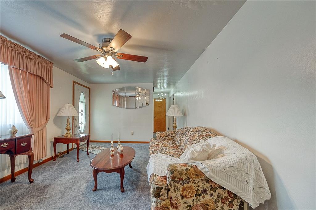 21 Spring Street Etna, PA 15223 - Photo 6 of 27 a bedroom with furniture and a chandelier