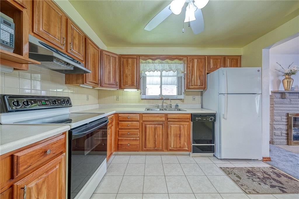 21 Spring Street Etna, PA 15223 - Photo 7 of 27 a kitchen with granite countertop a refrigerator a sink a stove and dishwasher