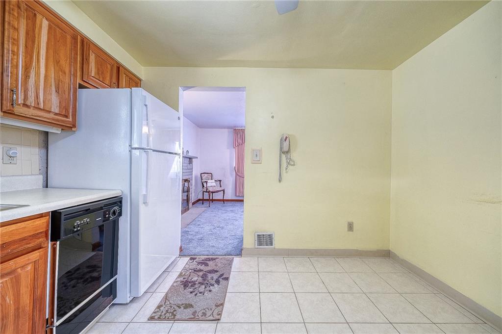 21 Spring Street Etna, PA 15223 - Photo 8 of 27 a kitchen with a sink a refrigerator and cabinets