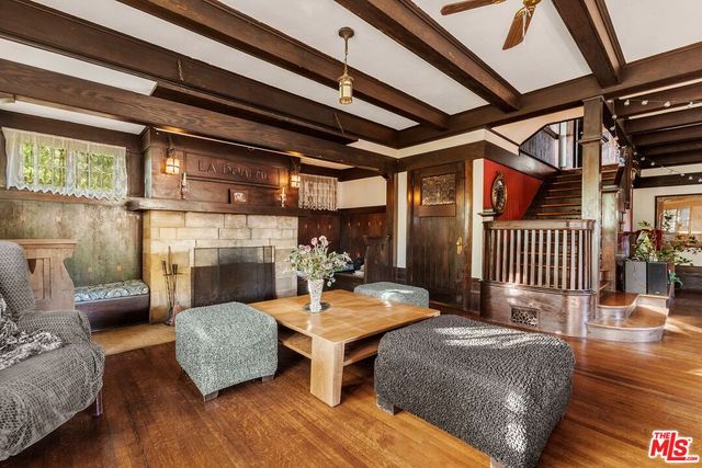 a living room with furniture and a floor to ceiling window