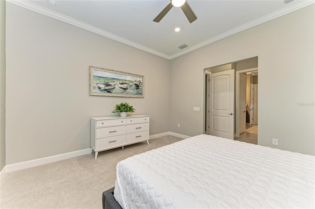 17631 Colebrook Circle Lakewood Ranch, FL 34202 - Photo 35 of 85 a bedroom with a bed and a painting on the wall