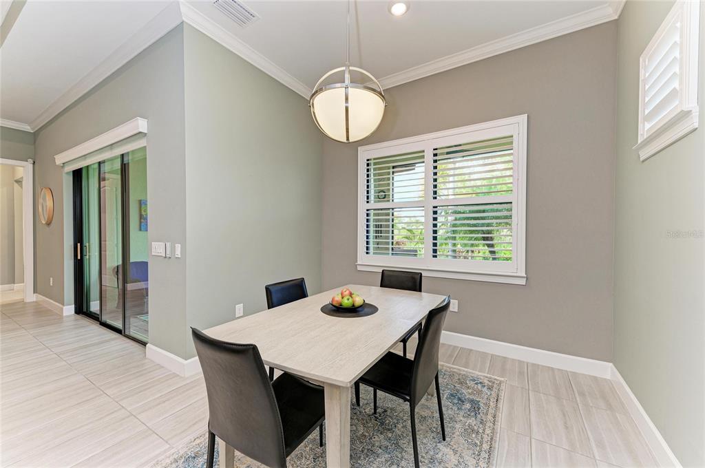 17631 Colebrook Circle Lakewood Ranch, FL 34202 - Photo 35 of 85 a view of a dining room with furniture window and wooden floor
