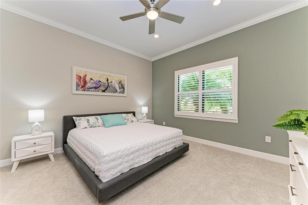 17631 Colebrook Circle Lakewood Ranch, FL 34202 - Photo 36 of 85 a bedroom with a bed and a chandelier