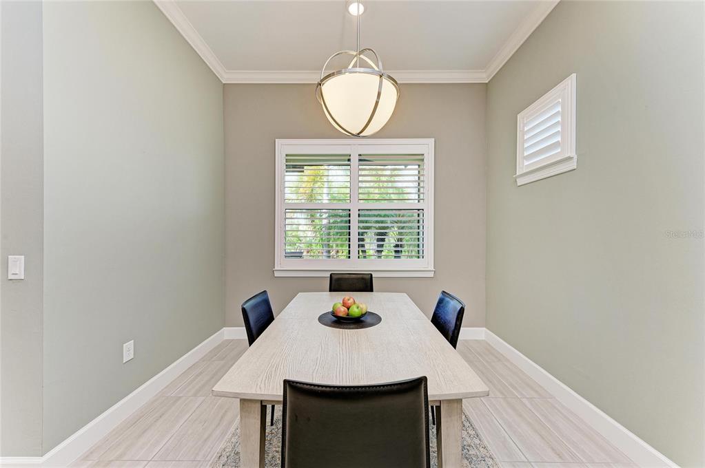17631 Colebrook Circle Lakewood Ranch, FL 34202 - Photo 36 of 85 a view of a dining room with furniture and a window