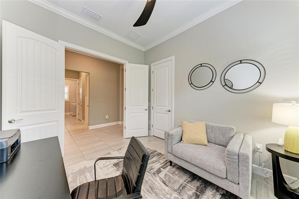 17631 Colebrook Circle Lakewood Ranch, FL 34202 - Photo 52 of 85 a living room with furniture a white bed and a lamp