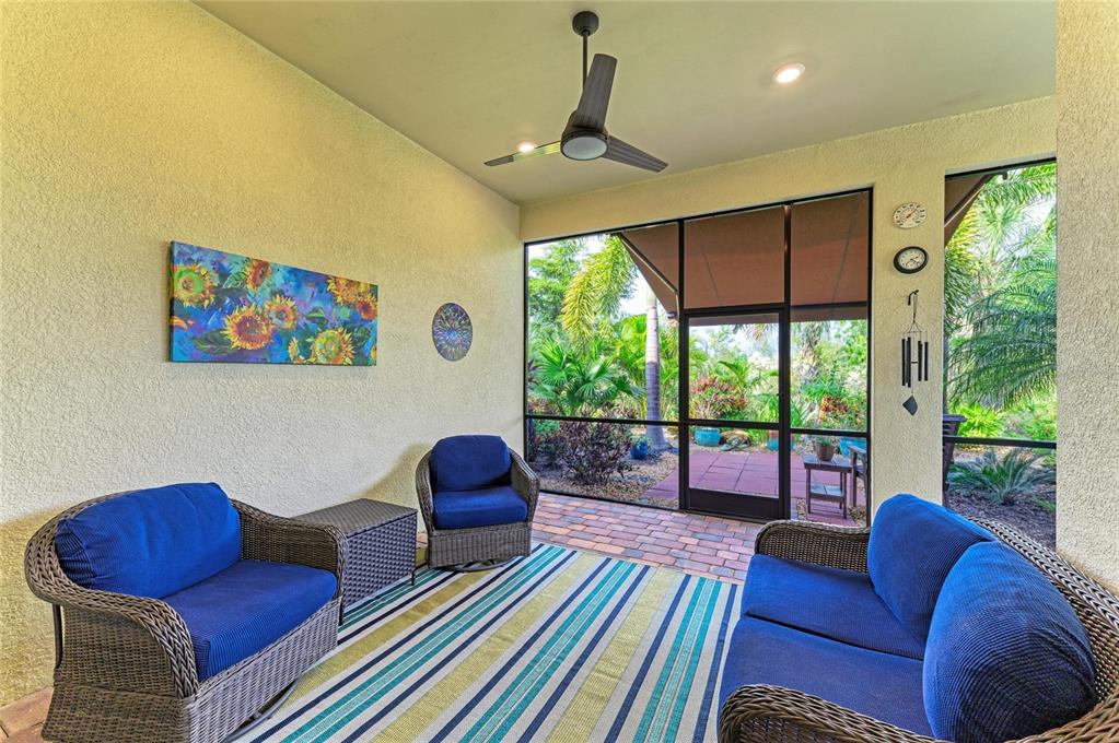 17631 Colebrook Circle Lakewood Ranch, FL 34202 - Photo 55 of 85 a living room with furniture and a floor to ceiling window