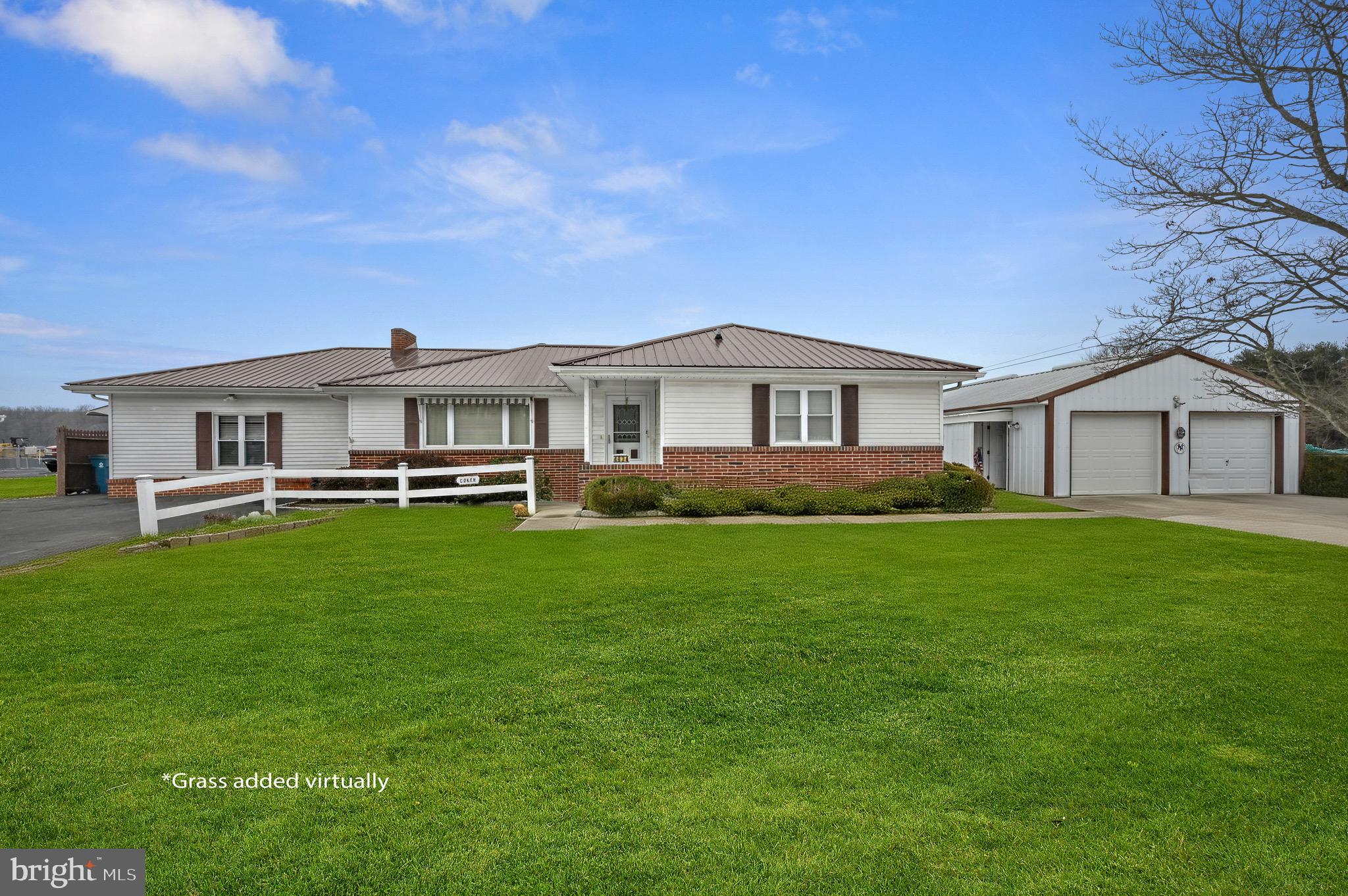 4634 Kenton Road Dover, DE 19904 - Photo 1 of 34 a front view of a house with a yard and trees