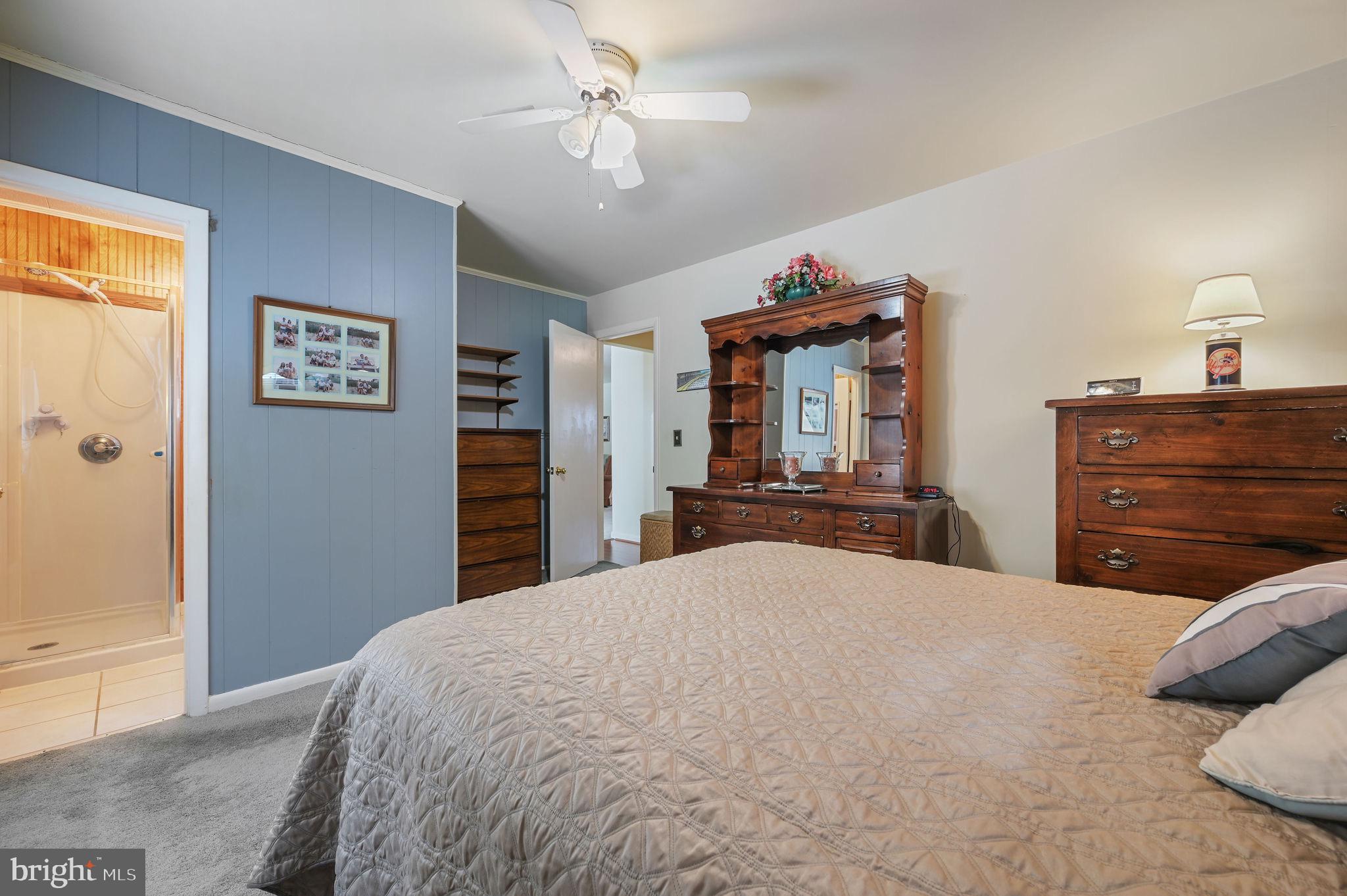 4634 Kenton Road Dover, DE 19904 - Photo 24 of 34 a bedroom with a large bed and a dresser