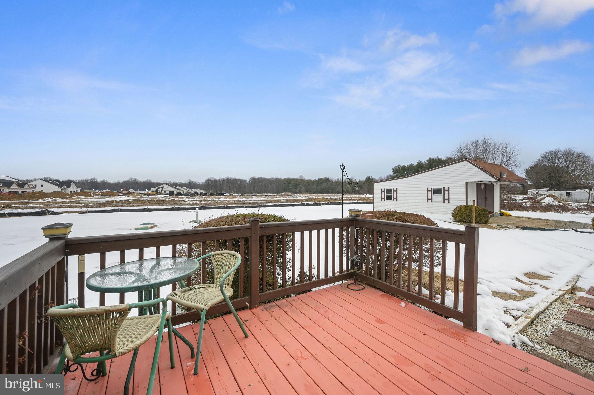 4634 Kenton Road Dover, DE 19904 - Photo 33 of 34 a view of a balcony with wooden floor and outdoor seating