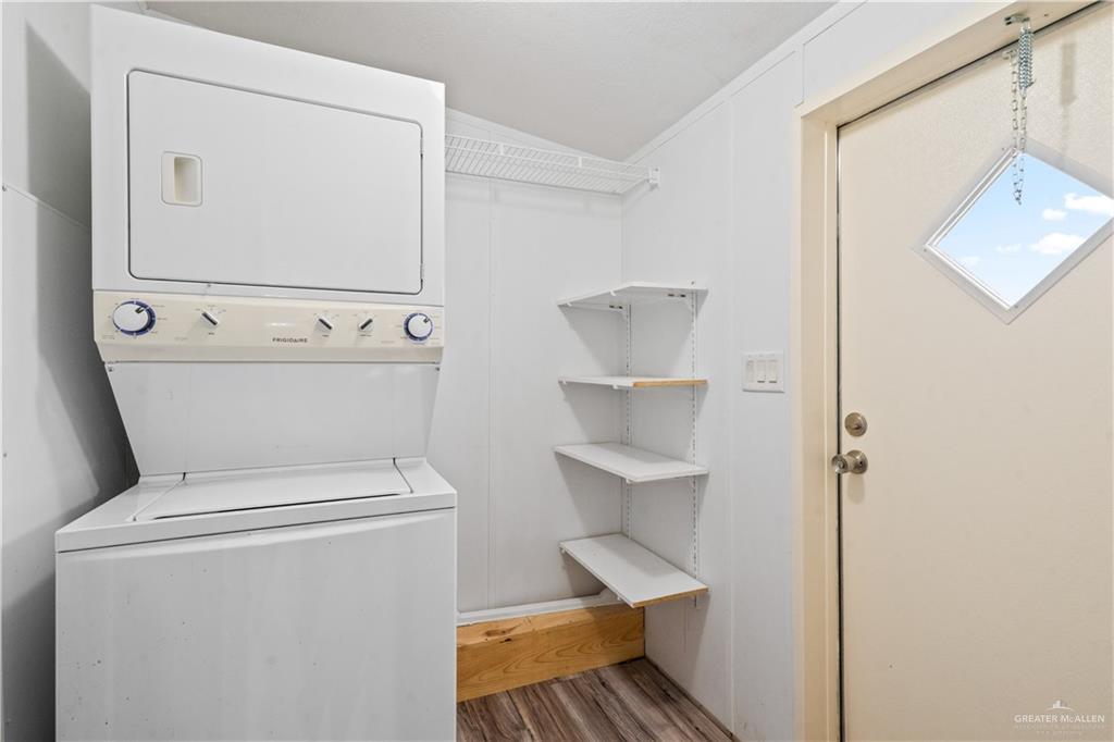 215 South Valley View Road, Unit 252 Donna, TX 78537 - Photo 8 of 19 Dedicated utility space featuring a stacked washer and dryer unit