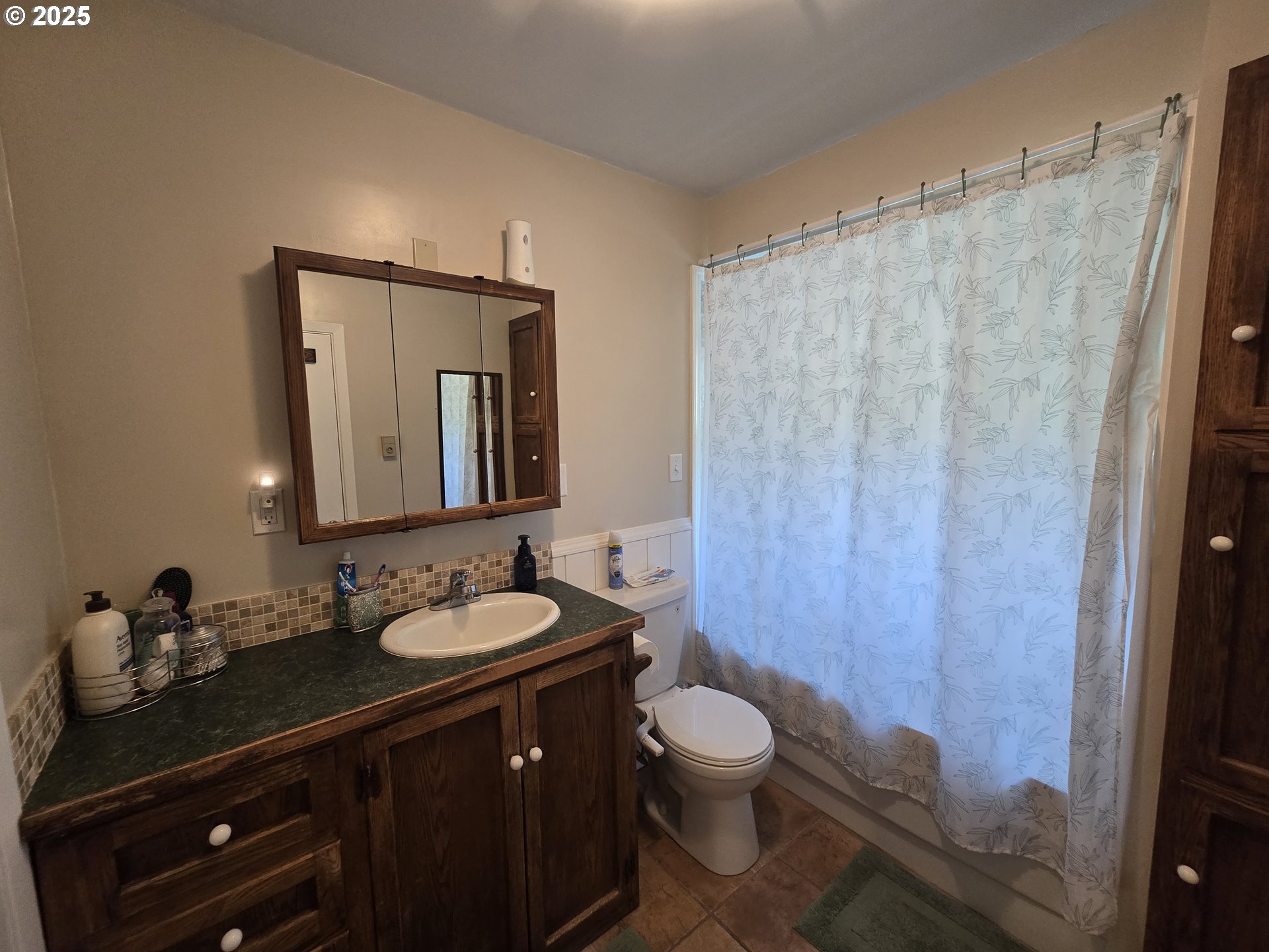 407 Residence Street Enterprise, OR 97828 - Photo 19 of 43 a bathroom with a granite countertop sink toilet a mirror and shower