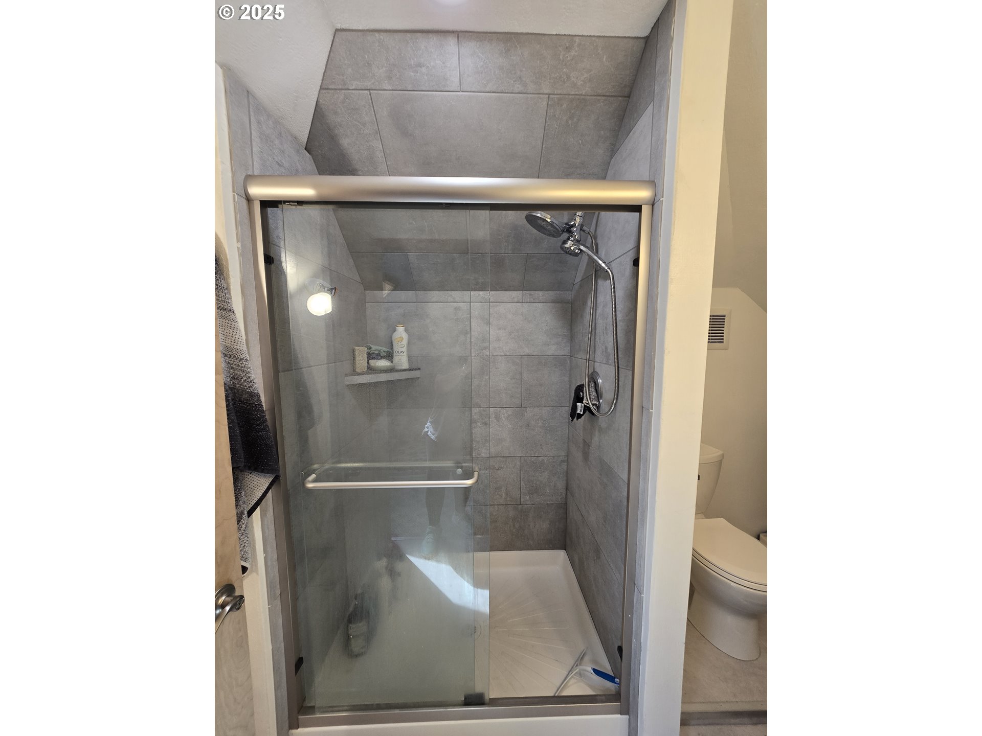 407 Residence Street Enterprise, OR 97828 - Photo 29 of 43 a bathroom with a glass shower door