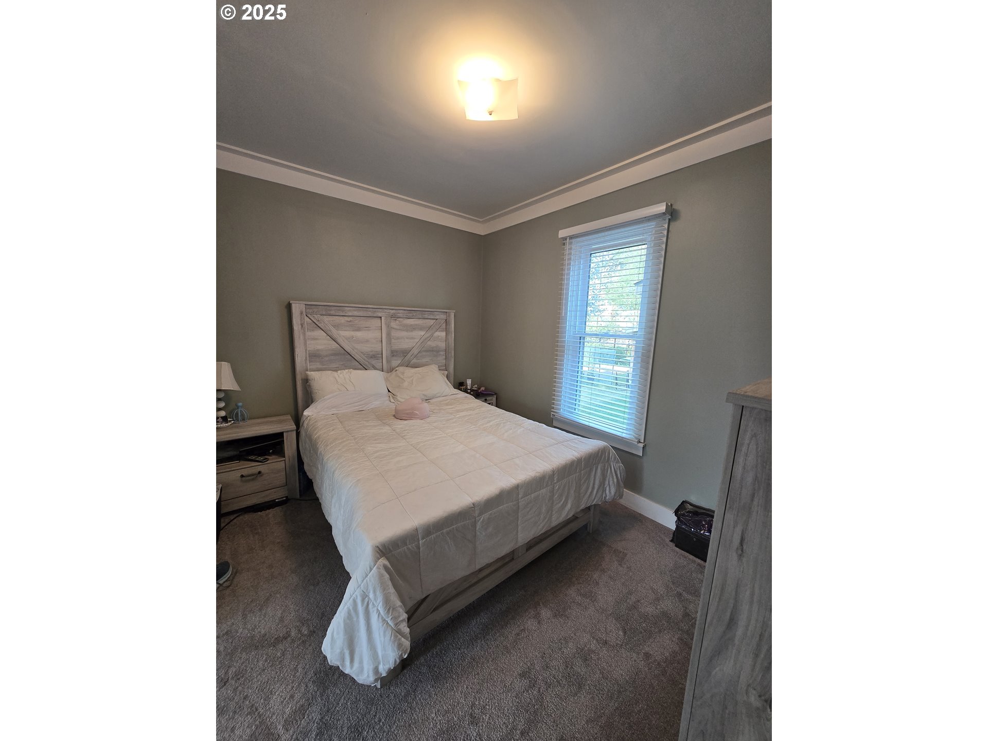 407 Residence Street Enterprise, OR 97828 - Photo 32 of 43 a bed sitting in a bedroom next to a window