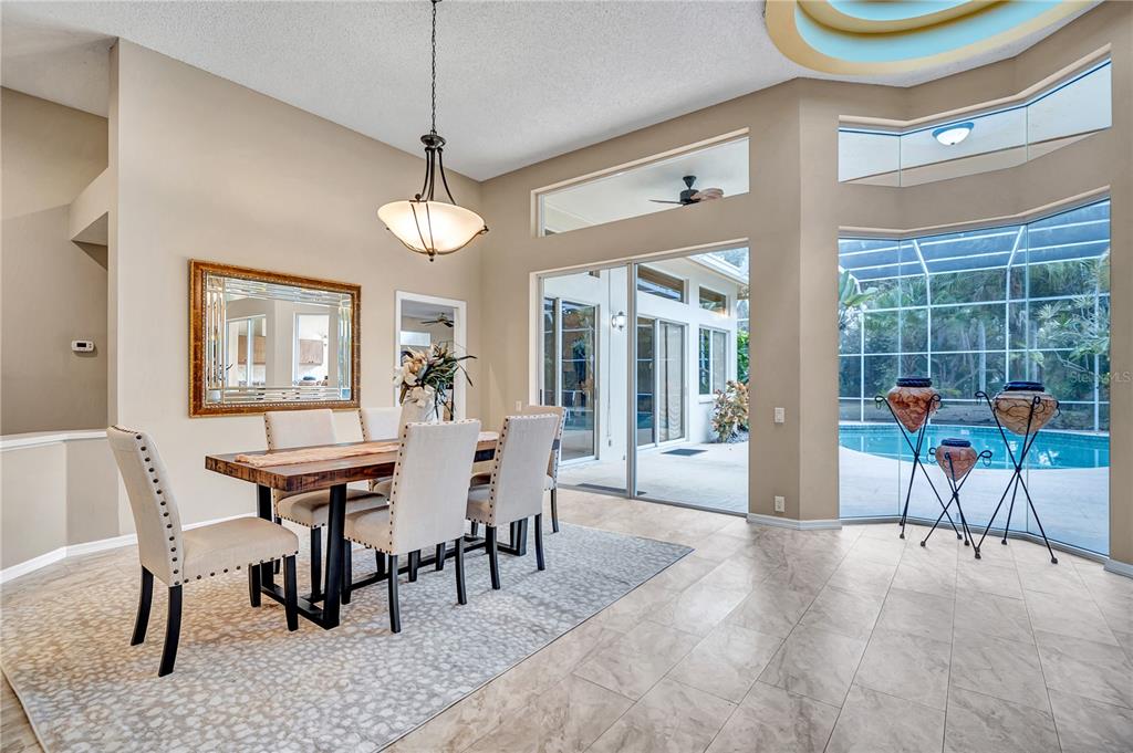 1343 Ranchero Drive Sarasota, FL 34240 - Photo 21 of 68 a dining room with furniture a chandelier and window