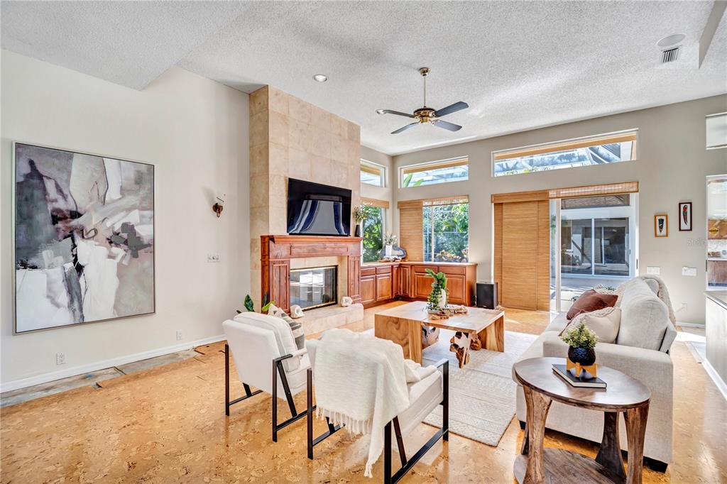 1343 Ranchero Drive Sarasota, FL 34240 - Photo 22 of 68 a living room with fireplace furniture and a flat screen tv