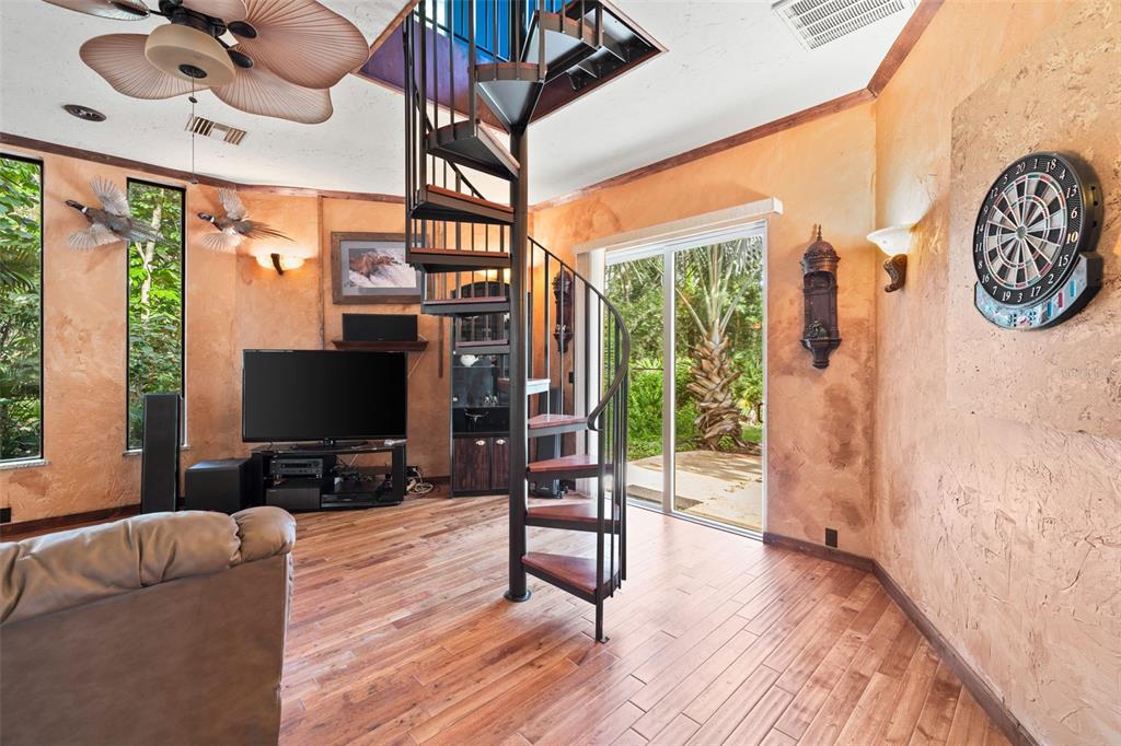 1343 Ranchero Drive Sarasota, FL 34240 - Photo 41 of 68 a living room with furniture a flat screen tv and a floor to ceiling window