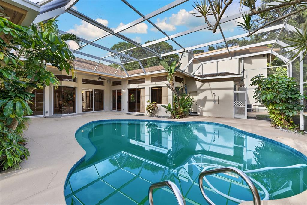 1343 Ranchero Drive Sarasota, FL 34240 - Photo 56 of 68 a view of a swimming pool with a patio