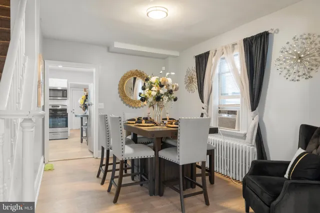 a view of a dining room with furniture a livingroom and chandelier
