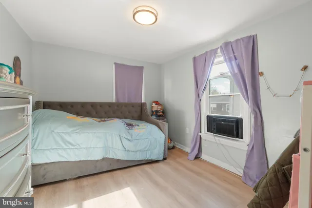 a spacious bedroom with a bed and a window