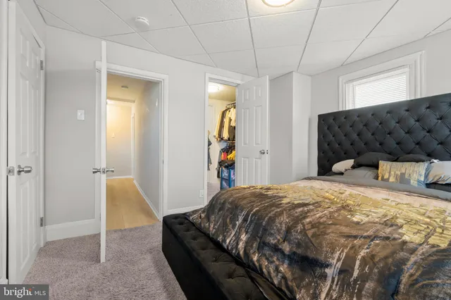 a bedroom with a bed and a couch