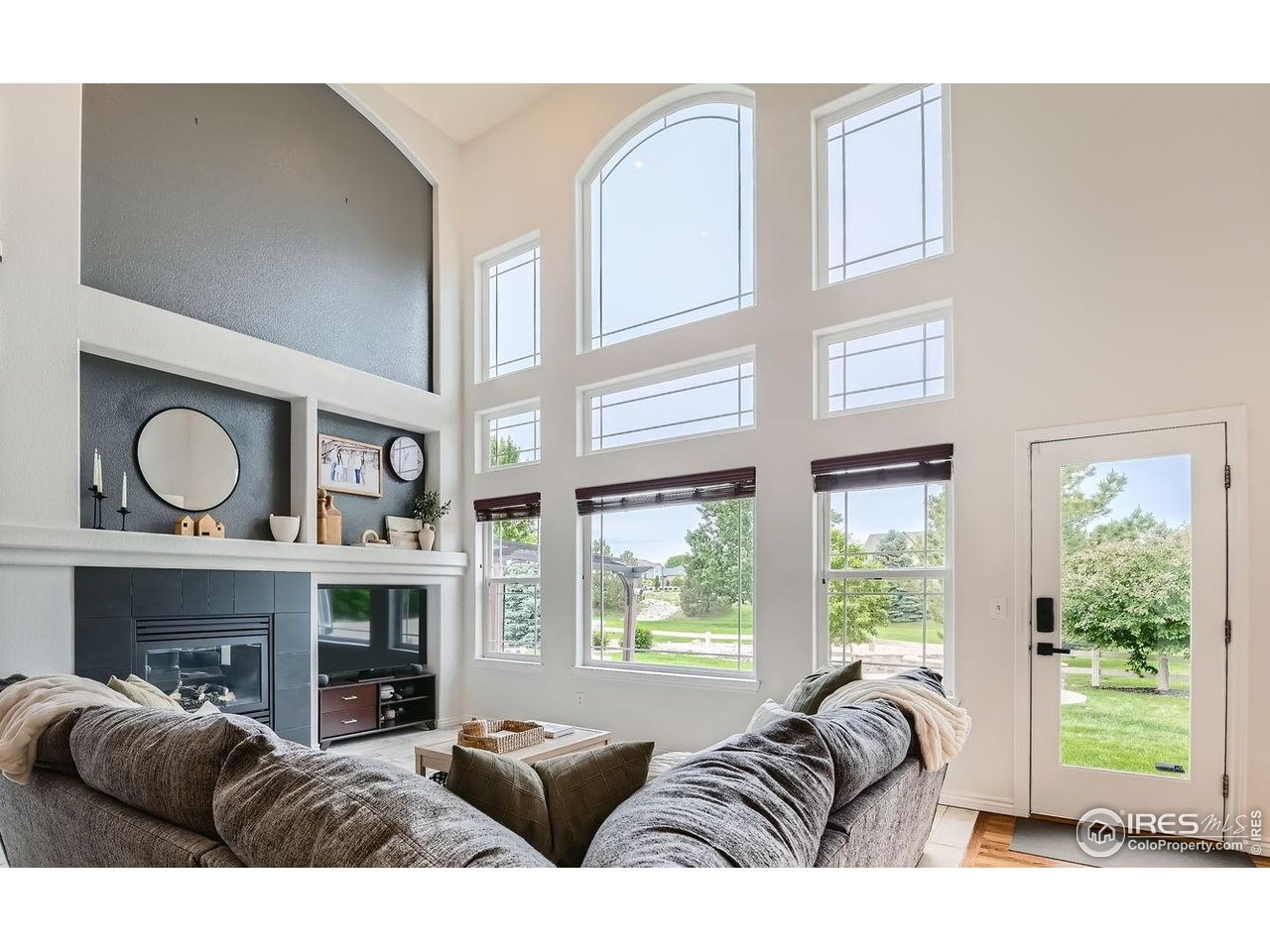 8839 Shetland Drive Frederick, CO 80504 - Photo 12 of 40 a living room with furniture a fireplace and a large window
