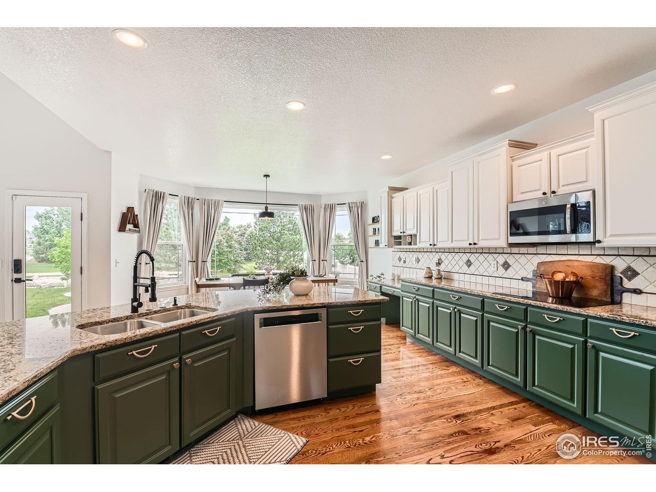 8839 Shetland Drive Frederick, CO 80504 - Photo 15 of 40 a kitchen with lots of counter top space sink and window