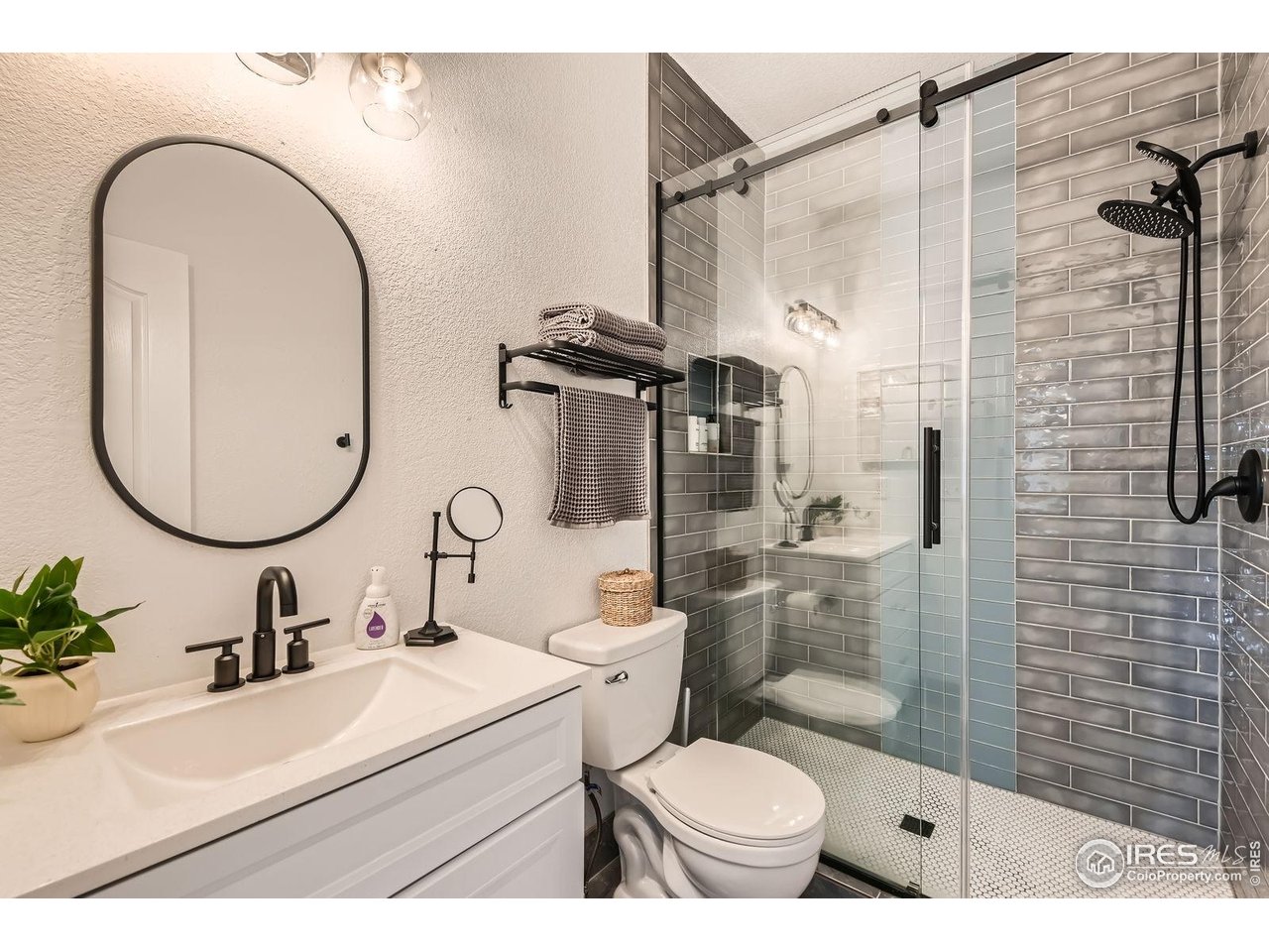 8839 Shetland Drive Frederick, CO 80504 - Photo 17 of 40 a bathroom with a sink toilet and shower