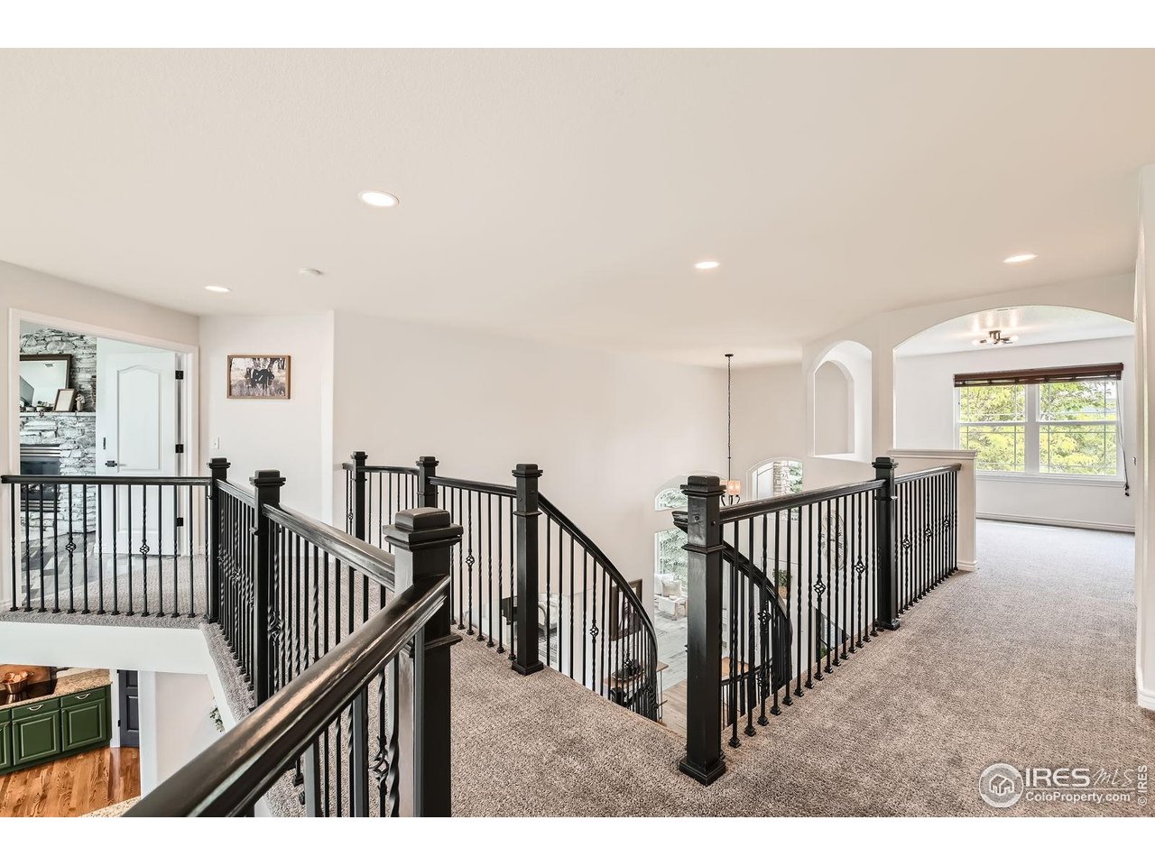 8839 Shetland Drive Frederick, CO 80504 - Photo 19 of 40 a view of staircase with wooden floor and windows
