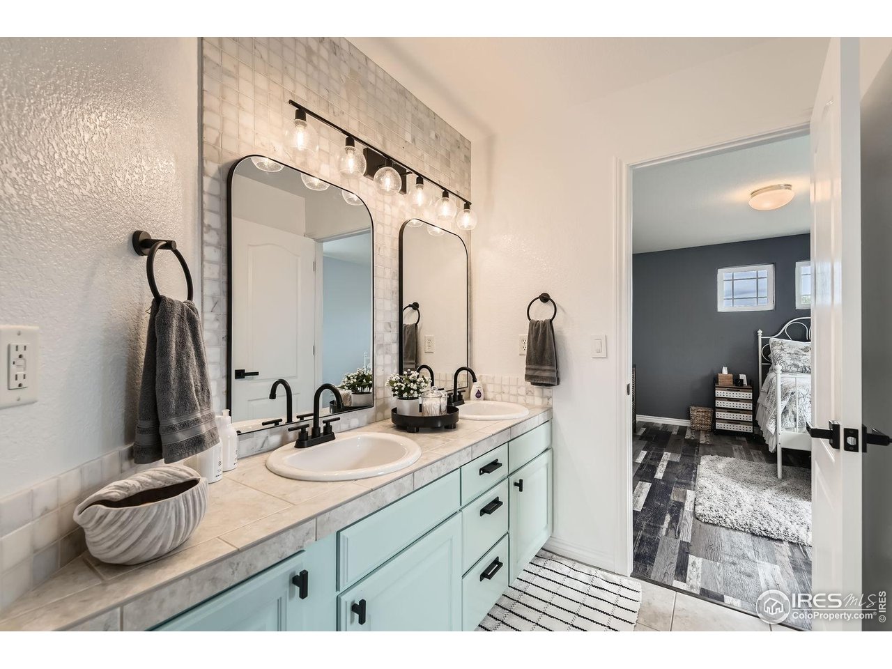 8839 Shetland Drive Frederick, CO 80504 - Photo 26 of 40 a bathroom with a sink double vanity and a mirror
