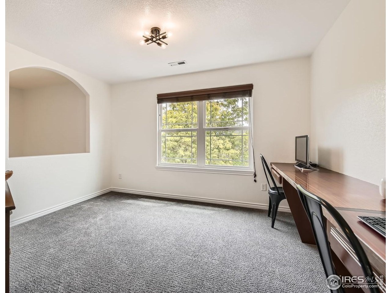 8839 Shetland Drive Frederick, CO 80504 - Photo 27 of 40 a workspace with furniture and a window