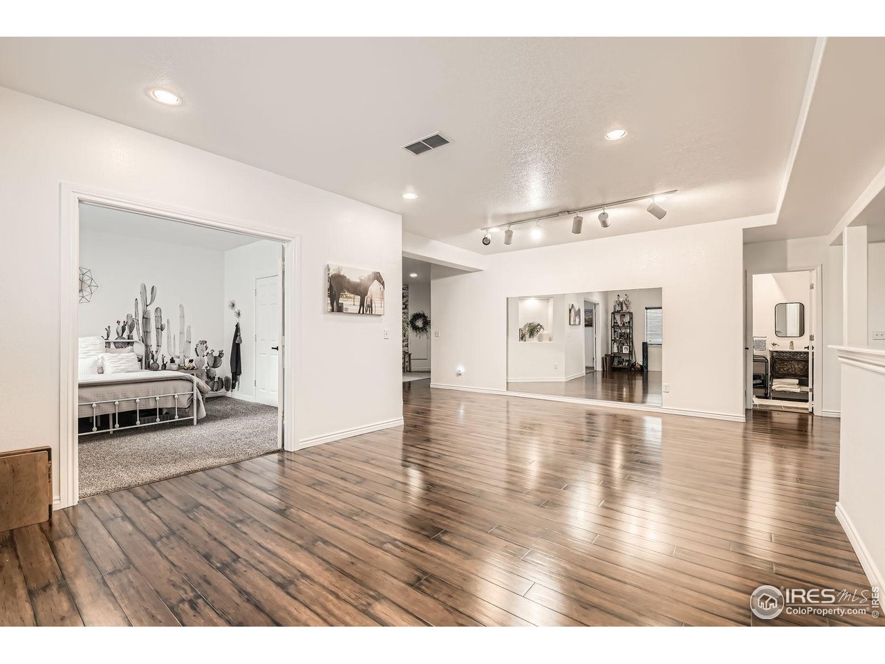 8839 Shetland Drive Frederick, CO 80504 - Photo 30 of 40 a view of a living room and wooden floor