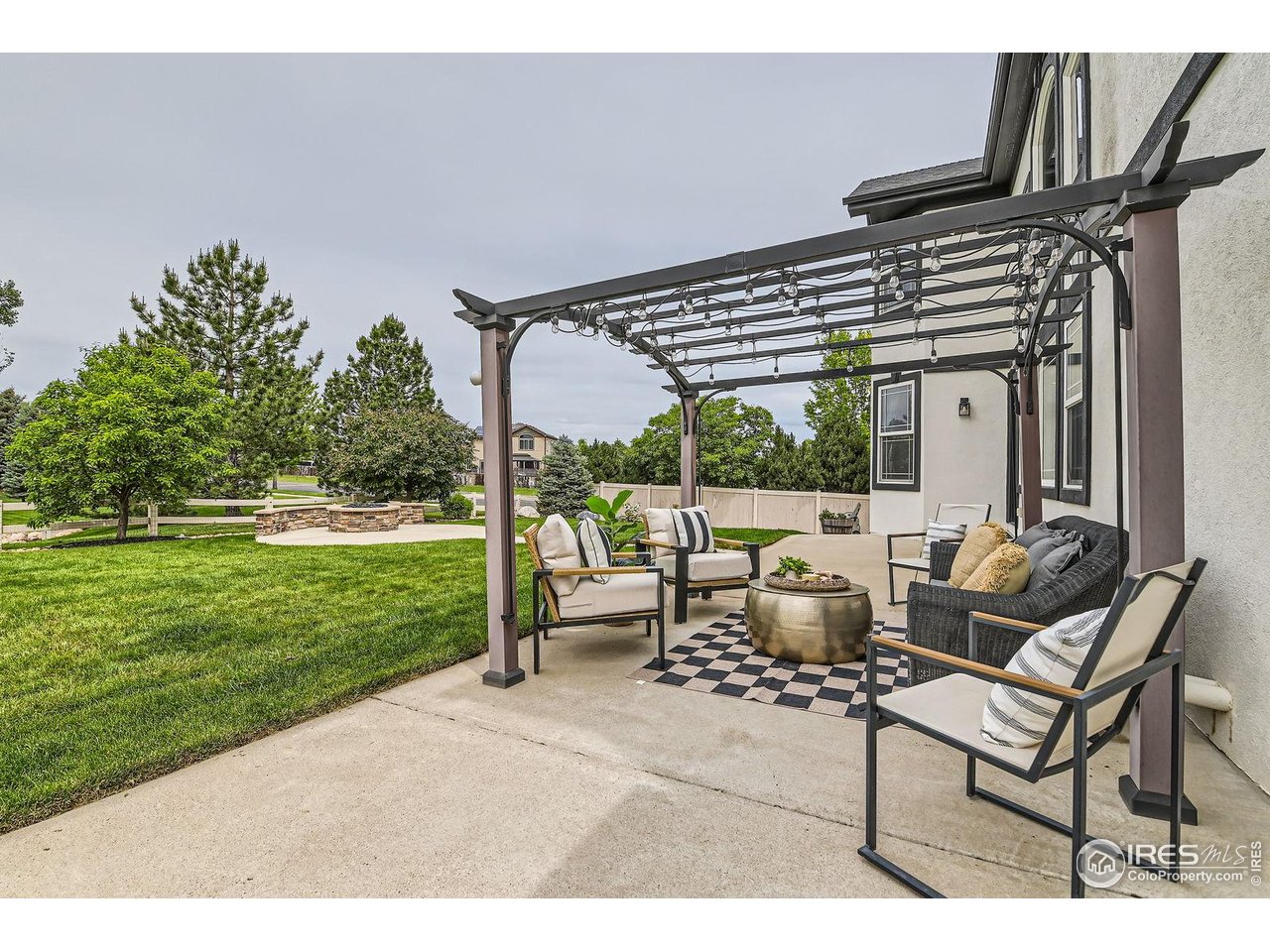 8839 Shetland Drive Frederick, CO 80504 - Photo 35 of 40 a backyard of a house with table and chairs